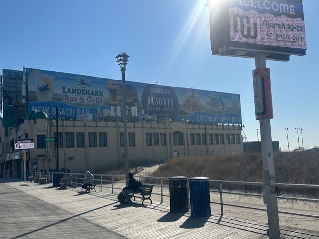 Atlantic City boardwalk with promotional billboards.