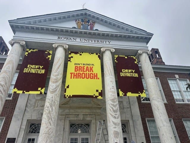 Rowan University building with motivational banners.