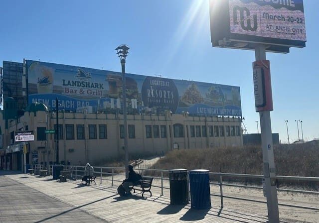 Atlantic City boardwalk with promotional billboards.