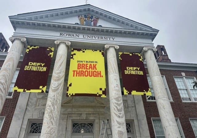 Rowan University building with motivational banners.