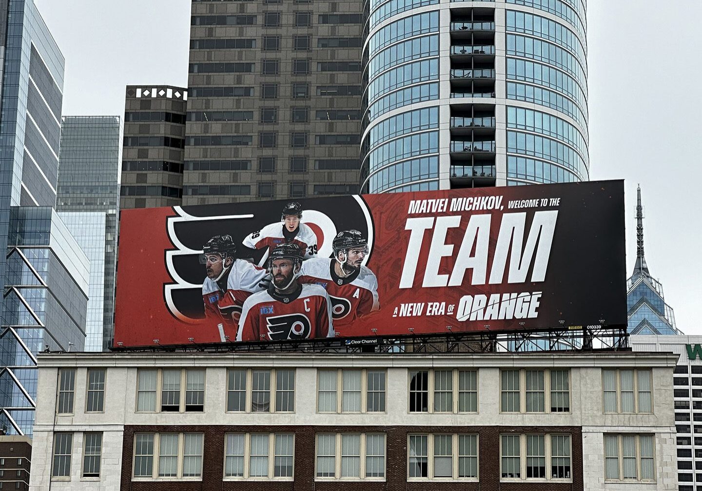 Billboard promoting the Philadelphia Flyers hockey team with players and team slogan.